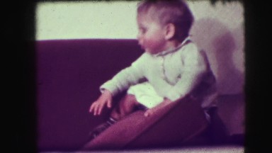 1942: an awesome looking kid trying to walk through the couch NEW YORK