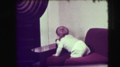 1942: baby reaches for snow globe adeo man catches baby from falling off couch