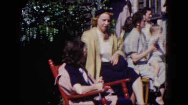 1964: Group of Women and Children Sitting Outdoors Watching Other Children Play