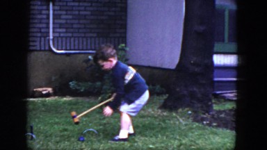1964: Young Boy Plays Croquet Alone in Yard Near House and Tree, Niagara Falls, Ontario