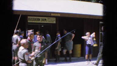 1965: boyscout reunited with their fishing rods and talking among themselves