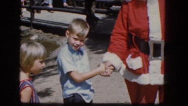 1965: a little boy and girl get to meet a man pretending to be santa claus.