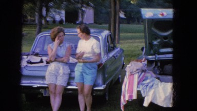 1965: ladies and gentlemen talking and socializing at a neighborhood yard