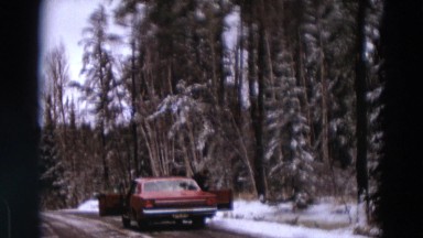 1967: man walks out of his car in a lonely road