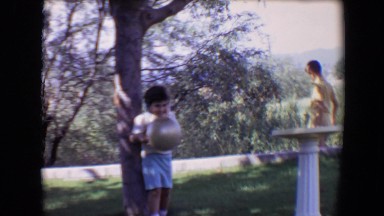 1967: young boy giggling while playing with a ball TUCSON, ARIZONA