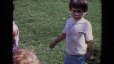 1967: children playing in the backyard a toddler cries