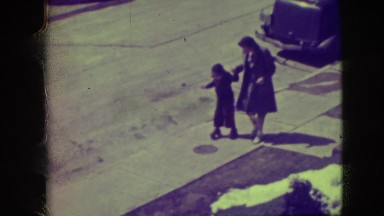 1945: Mother Helping Child Learn to Roller Skate New York