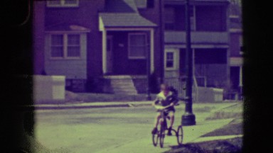 1945: A Cute Little Boy Racing Down the Sidewalk on a Tricycle New York