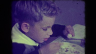 1946: a cute young boy eating and talking about the food on his plate NEW YORK