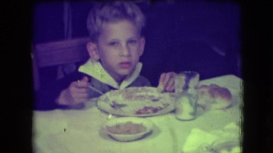 1946: boy sitting at table eating his food NEW YORK