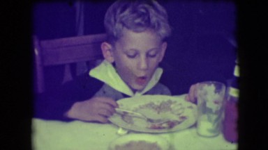 1946: a cute young boy eating and talking about the food on his plate NEW YORK