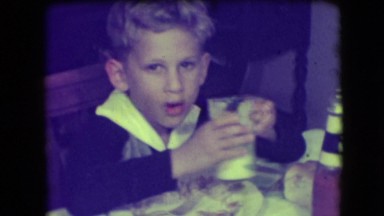 1946: little boy is drinking his milk during dinner NEW YORK