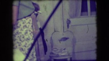 1946: a boy is dutifully drying and stacking dishes for his mother