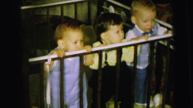 1964: Three Adorable Toddlers Peering Over Playpen Railing in Camden