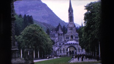 1969: people walking from and towards a cathedral in a square PARIS, FRANCE