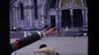 1969: A Man Giving Directions to Passersby on a Large Square in Lourdes