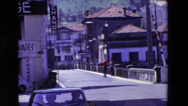1969: Watching Two Men Walking in the European City Lourdes, France