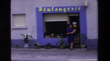 1969: woman walks out of a store and tries to cross the street LOURDES, FRANCE
