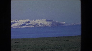 1971: A Beautiful View of a Coastal City or Town with Buildings on the Water
