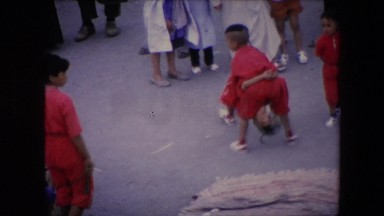 1971: young boys are performing acrobatic tricks at an outdoor marketplace