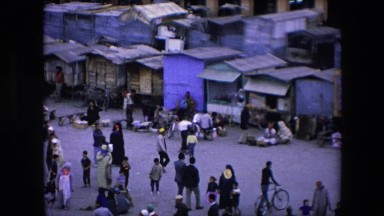1971: village town with lot people shopping, walking and engaged in activities