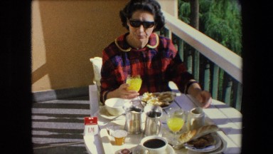 1971: an adult woman taking a hearty breakfast sitting on a terrace ALGERIA