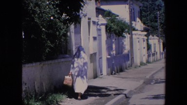1971: a muslim woman in a burka on the way home from the market with a basket