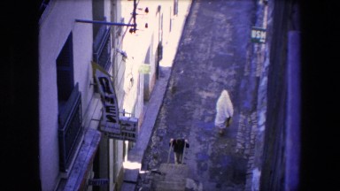 1971: woman wearing full body covering walking past dames sign zoom in on power