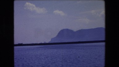 1971: panoramic view of the horizon across the ocean with mountains