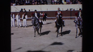 1971: matadors in a stadium on horses performing maneuvers for the audience