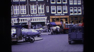 1967: cars passing by waving huge road parked cars buildings AMSTERDAM