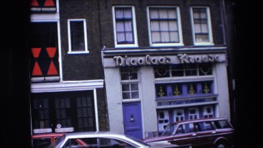 1967: street cars parked tower road restaurants building AMSTERDAM, NETHERLANDS