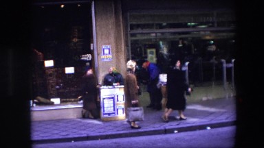 1967: a man is talking to a woman that is selling lottery tickets BRUSSELS
