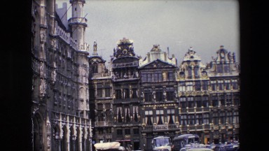1967: showing historic european buildings with old classic cars on a cloudy day