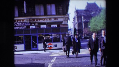 1967: People Walking on Road Near Shop in Calais, France