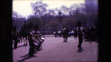 1969: group of people in red and black uniforms marching