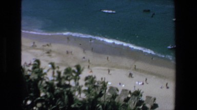 1972: Shore of the Sea with Lot of People on the Shore and Boats in the Water