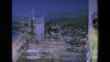 1972: one lady waving camera beautiful seaside view skyscrapers MAZATLAN MEXICO