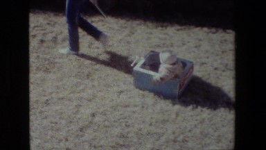 1981: girl carrying baby pulling grass cars parked moving around sunny weather