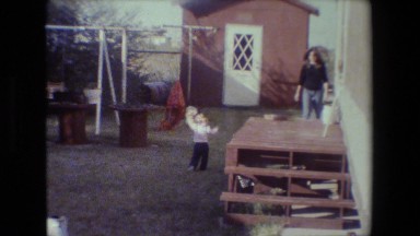 1981: mother and child backyard having fun LANSING MICHIGAN