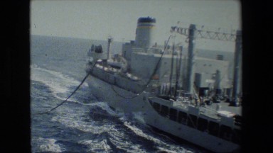 1981: a sailor watches from his ship as a second ship interacts with his.