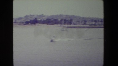 1981: the old navy warship sailing from the city with the view of the city.