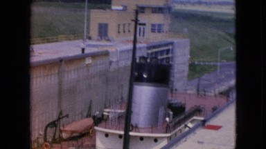 1964: tugboat helping a ship come into port. NIAGRA FALLS NEW YORK