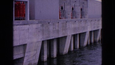 1964: view of a dam with a boat near it. NIAGRA FALLS NEW YORK