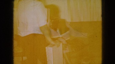 1965: a family gathered in the living-room as children play on the floor