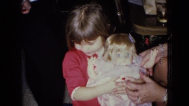 1965: young girl forced to pose with doll WELLSBURG IOWA