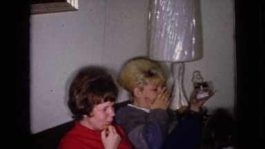 1965: women are seen in beautiful dresses waving to camera WELLSBURG IOWA