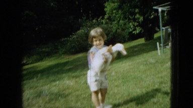 1965: little girl outside, holding a duck. WELLSBURG IOWA
