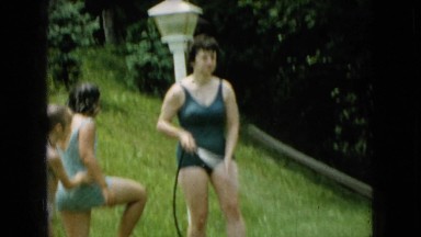 1965: family playing outside with a hose WELLSBURG IOWA