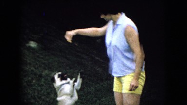 1965: a woman is teaching her dog to stand up WELLSBURG IOWA